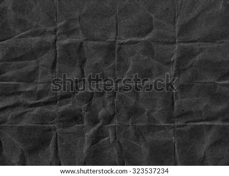 Crumpled black paper. Grunge paper texture. Black abstract background
