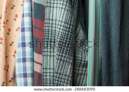 Vintage cloth. Hipster wardrobe. Clothes hanging on hangers. Clothes in the closet. Fabric textures. Stylish cloth. Shoping background.