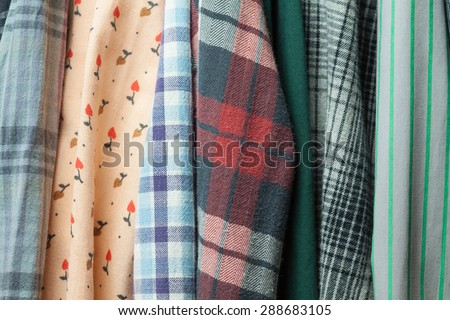 Vintage cloth. Hipster wardrobe. Clothes hanging on hangers. Clothes in the closet. Fabric textures. Stylish cloth. Shoping background.