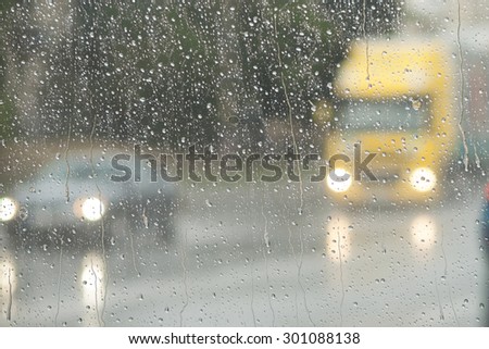 Blurry backdrop. Rainy window. View from window to cityscape. Summer autumn rain. Weather template.
