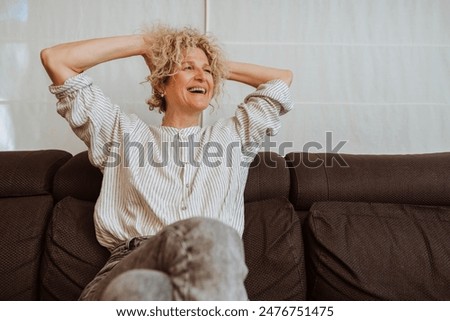 Similar – Image, Stock Photo Happy middle-aged woman smiling while looking out the window.