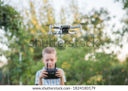 Similar – Image, Stock Photo Little kid operating drone in field