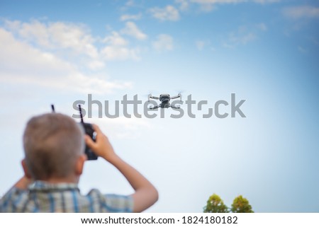 Similar – Image, Stock Photo Little kid operating drone in field