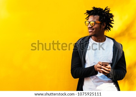 Similar – Image, Stock Photo Trendy black guy standing against city building