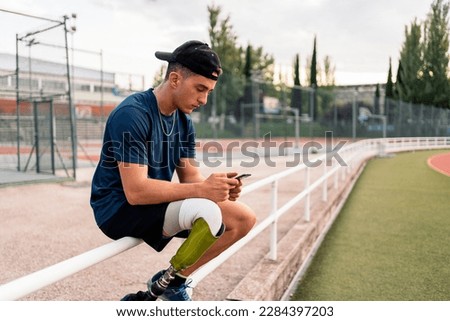 Similar – Image, Stock Photo Disabled athlete using phone