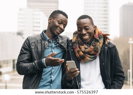 Similar – Image, Stock Photo Elegant black man talking smartphone leaning building