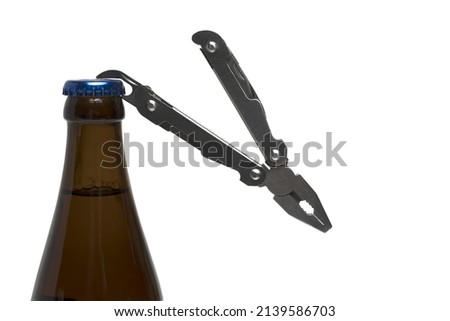 brown beer bottle close up with blue crown cork and bottle opener on pocket knife on white background ストックフォト © 