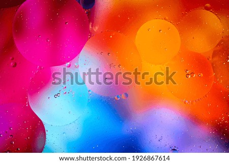 Beautiful abstract background from mixed water and oil in orange and purple color. Abstract macro background. Desktop wallpaper. Texture. Colored bubbles