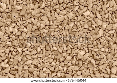 background and texture of stone crushed stone or pebble of sepia color