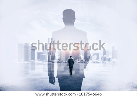 Back view of young businessman walking on abstract city background. Success and development concept. Double exposure 