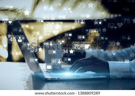 Side view and close up of businessman hands using laptop with social media icons on blurry outdoor background. Communication and network concept. Double exposure 