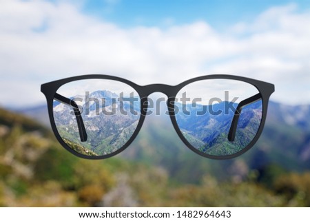 Abstract landscape view though eyeglasses. Blurry background. Vision concept