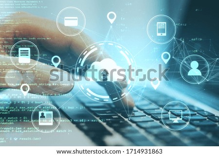 Hand using laptop with online shopping and cloud computing diagram. Cloud computing and communication concept.