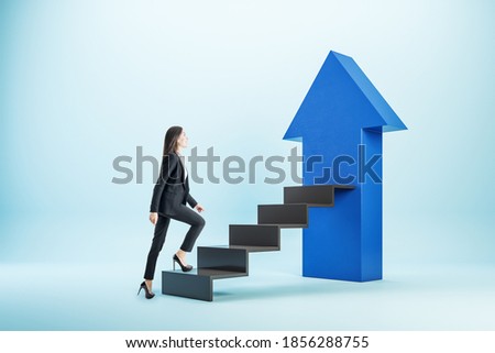 Young businesswoman climbing on black stairs with blue arrow. Start up and success concept.