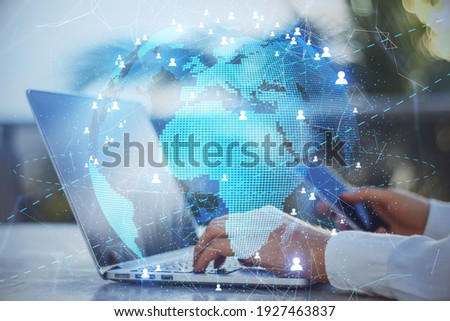Blockchain and telecommunication concept with digital Earth with glowing citylights and people signs on businessman with smartphone and laptop background. Double exposure