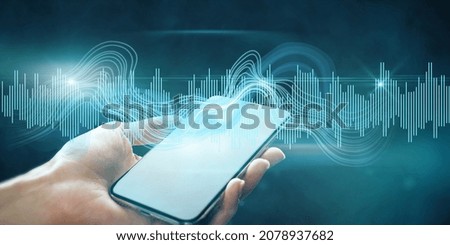 Close up of female hand holding tablet with digital sound wave on blurry background. Technology, music, frequency and energy concept. Double exposure