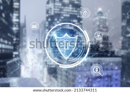 Glowing shield hologram on blurry city background. Antivirus, protection and safety concept. Double exposure