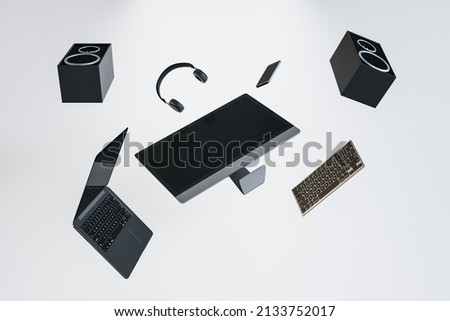 Abstract flying tech pieces on white background. Laptop computer, speakers and headphones. Music and technology concept. 3D Rendering