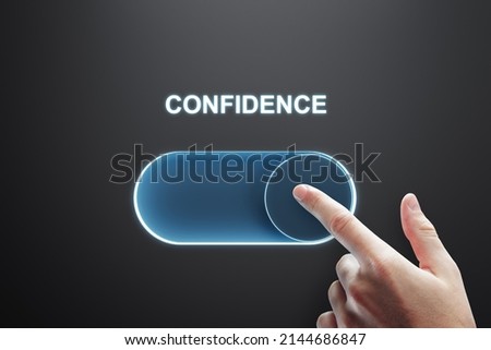 Close up of male finger turning on slider button on black background. Confidence and success concept