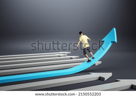 Back view of casual young man balancing on growing blue arrow on gray background. Improving business and changing direction concept