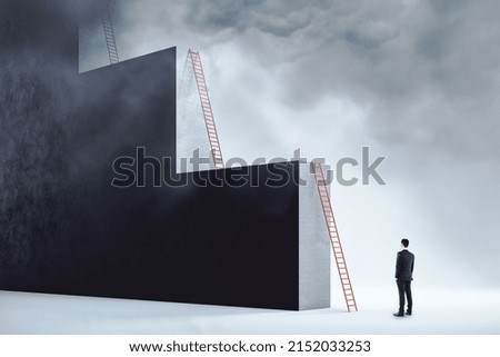 Ambition and career growth concept with man staying in front of red ladder leaning on a monumental wall in the form of stairs