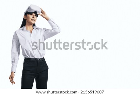 Virtual reality concept with standing young woman looking up and VR headset on her head isolated on white background with place for your logo or text, mockup