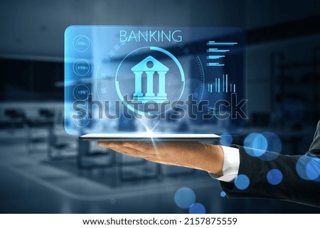 Online banking application concept with digital bank building sign with indicators on virtual projection from digital tablet on man hand