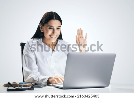 Communication concept with young pretty woman chating with collegue via online video service by laptop isolated on light grey wall background, close up