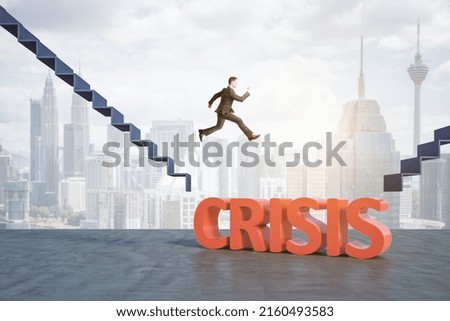 Financial crisis and risk management concept with businessman in black suit jumping from stairs between gap with crisis word to new stairs at city background