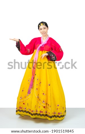 The woman wearing colorful Hanbok, Korean traditional dress on white background isolated.
