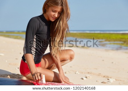 Similar – Image, Stock Photo Crop female surfer waxing surfboard with basecoat