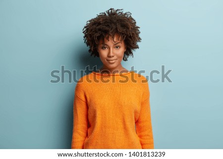 Similar – Image, Stock Photo Photo of delighted curly woman keeps both hands on waist, smiles gently, has slim figure, wears white t shirt and black jeans, being in good mood, stands self assured against white background