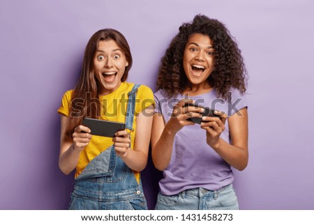 Similar – Image, Stock Photo Delighted ethnic couple playing video game together