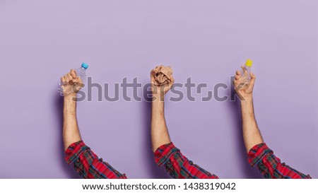 Image, Stock Photo Male hand holding squashed plastic bottle