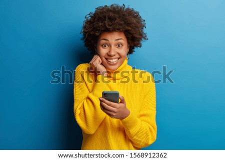 Similar – Image, Stock Photo Delighted black woman browsing smartphone near car