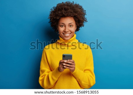 Similar – Image, Stock Photo Delighted black woman browsing smartphone near car