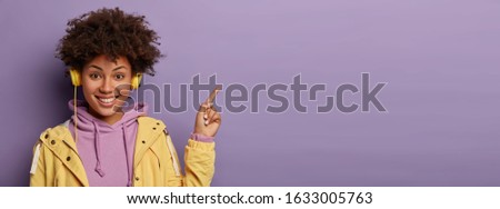 Similar – Image, Stock Photo Positive black female meloman speaking on smartphone in library
