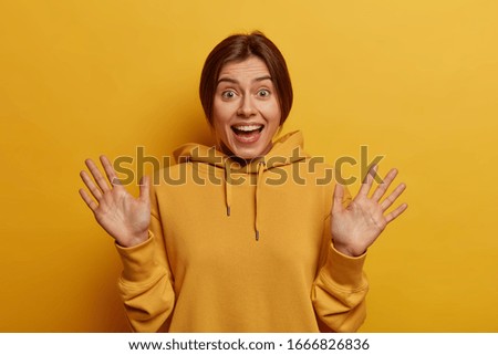 Similar – Image, Stock Photo Woman in yellow hoodie taking selfie on smartphone on rocky shore