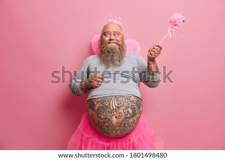 Happy celebration, fantasy, family fun party concept. Positive friedly looking plump man comes from world of fairies, makes your dreams come true, has different activities with children on child show