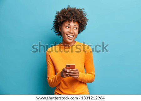 Similar – Image, Stock Photo Delighted black woman browsing smartphone near car