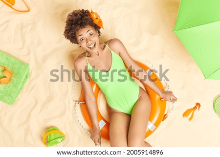 Similar – Image, Stock Photo Lady sitting on sandy coast near sea