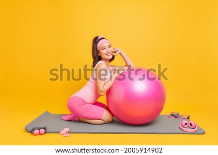 Similar – Image, Stock Photo Positive Asian sportswoman leaning on barbell in modern gym and looking at camera