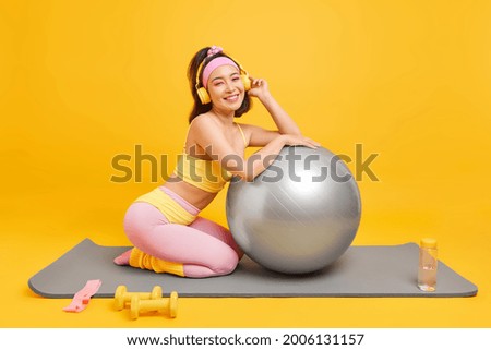 Image, Stock Photo Positive Asian sportswoman leaning on barbell in modern gym and looking at camera