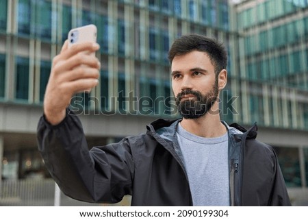 Similar – Image, Stock Photo Focused man using smartphone on rooftop