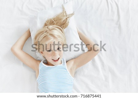 Similar – Image, Stock Photo Little girl laying playing on grass enjoying summer day during vacation trip
