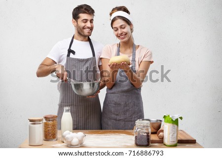 Similar – Image, Stock Photo Cooking doughnuts process. Homemade dough and deep-fried donuts, top view