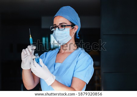 Latin woman doctor holding vaccine injection for coronavirus covid 19 World immunization in Latin America pandemic