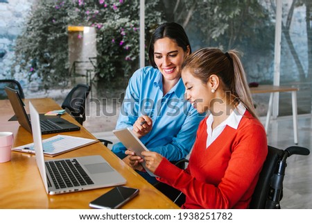 Young latin woman in wheelchair working with computer at workplace or office in Mexico city Photo stock © 