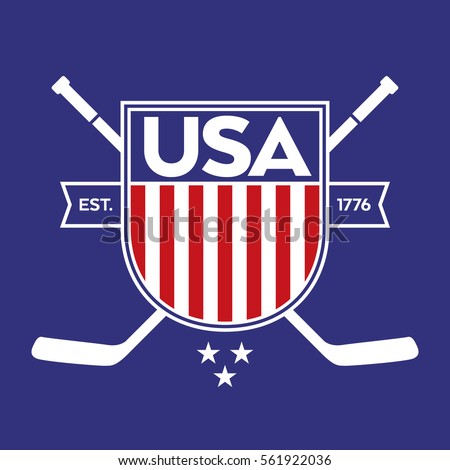 A classic USA shield with stars and stripes over a blue background. This sports crest includes crossed hockey sticks and the establishment date of the United States of America.