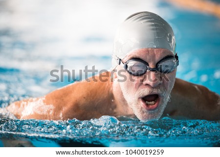 Similar – Image, Stock Photo Active senior man swimming and splashing in water